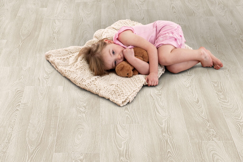 Young girl lying on Elka Frosted Oak floors